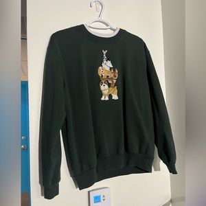 Green sweatshirt with embroidered dog graphic with white mock neck under neck